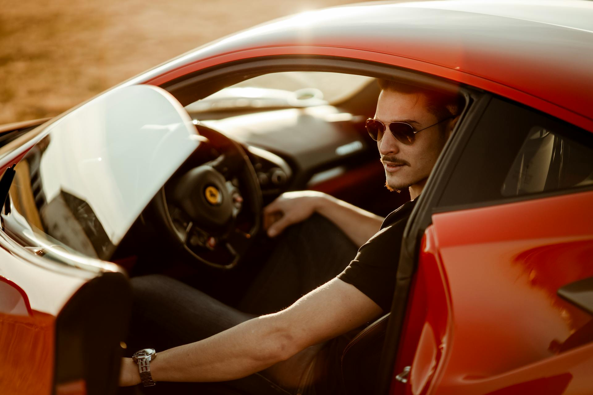 driver sitting in car closing driver's door